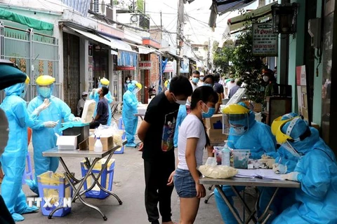Lấy mẫu xét nghiệm người dân sinh sống trong các khu phố đã phát hiện người dương tính với virus SARS-CoV-2 tại Đà Nẵng. (Ảnh: Quốc Dũng/TTXVN)