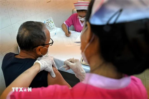 Nhân viên y tế tiêm vaccine ngừa COVID-19 cho người dân tại Phnom Penh, Campuchia, ngày 10/3/2021. (Ảnh: AFP/TTXVN)