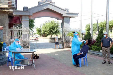 Lực lượng y tế lấy mẫu xét nghiệm tại nhà thờ xứ Lộc Thủy thôn Đông Hà 2 xã Thạch Long huyện Thạch Hà, tỉnh Hà Tĩnh. (Ảnh: Công Tường/TTXVN)