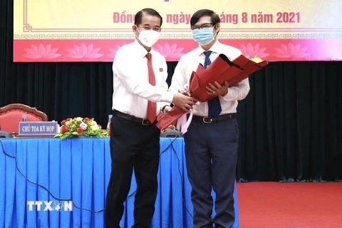 Chủ tịch HĐND tỉnh Đồng Nai Thái Bảo tặng hoa chúc mừng ông Nguyễn Sơn Hùng được bầu làm Phó chủ tịch UBND tỉnh. (Ảnh: TTXVN phát)