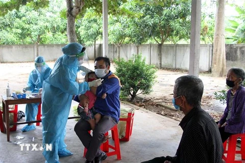 Lực lượng y tế lấy mẫu xét nghiệm sàng lọc cộng đồng tại xã Nghi Ân, thành phố Vinh (Nghệ An). (Ảnh: Văn Tý/TTXVN)