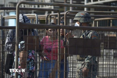 Thân nhân của các tù nhân hỏi tin tức sau vụ bạo động tại nhà tù ở Guayaquil, Ecuador, ngày 28/9. (Ảnh: AFP/TTXVN)