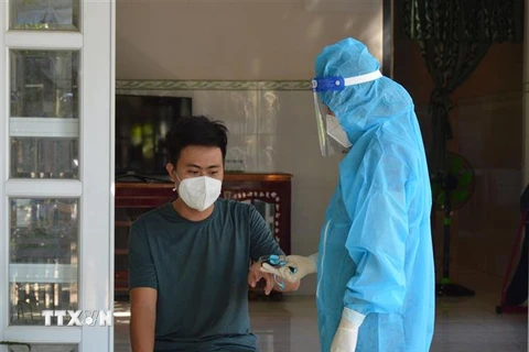 Cán bộ Trạm Y tế xã Bình Thành, huyện Thanh Bình, tỉnh Đồng Tháp đến kiểm tra sức khỏe, đo chỉ số SpO2 cho bệnh nhân COVID-19 đang theo dõi, điều trị tại nhà. (Ảnh: Nhựt An/TTXVN)