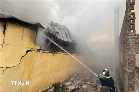 Công an thành phố Hà Nội nỗ lực dập tắt đám cháy. Ảnh: TTXVN phát