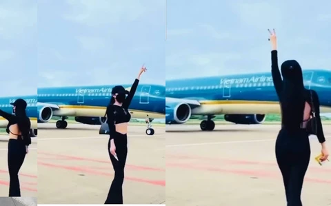 Hình ảnh cô gái nhảy múa trước máy bay đang di chuyển trong khu vực sân đỗ. (Nguồn: Tuoitre)