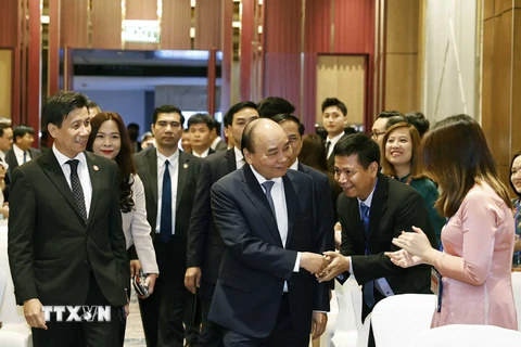 Chủ tịch nước Nguyễn Xuân Phúc đến dự buổi gặp gỡ cán bộ, nhân viên các cơ quan đại diện và đại diện cộng đồng người Việt Nam tại Indonesia. (Ảnh: Thống Nhất/TTXVN)