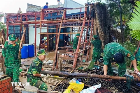 Bộ đội Biên phòng Cà Mau giúp người dân xã Khánh Hội, huyện U Minh dựng lại nhà bị sập do ảnh hưởng cơn bão số 1. (Ảnh: TTXVN phát)