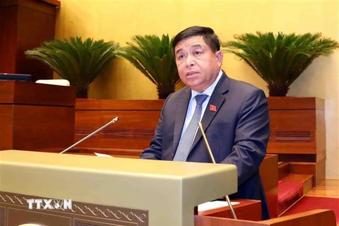 Bộ trưởng Bộ Kế hoạch và Đầu tư Nguyễn Chí Dũng trình bày Báo cáo Đánh giá giữa Nhiệm kỳ Thực hiện Kế hoạch Phát triển Kinh tế - Xã hội 5 năm 2021-2025 và Kế hoạch Cơ cấu lại nền Kinh tế giai đoạn 2021-2025. (Ảnh: Phạm Kiên/TTXVN)