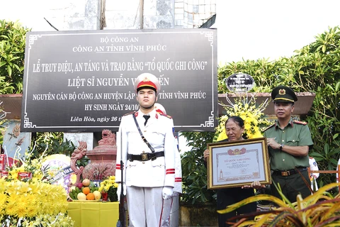 Đại tá Nguyễn Văn Công, Phó Giám đốc Công an tỉnh trao Bằng “Tổ quốc ghi công” cho đại diện gia đình liệt sĩ Nguyễn Văn Hiến. (Nguồn: Báo Vĩnh Phúc)