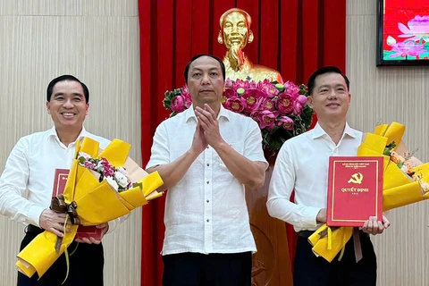 Ông Lâm Minh Thành, Chủ tịch UBND tỉnh Kiên Giang trao quyết định cho các ông Trần Minh Khoa (bìa phải) và Huỳnh Quang Hưng. (Nguồn: Vietnamnet)