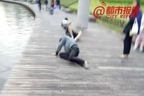 Nhân viên bị phạt bò quanh hồ. (Nguồn: CCTV News)