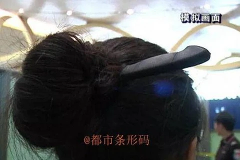 Người phụ nữ thản nhiên giấu dao vào búi tóc khi đi máy bay. (Nguồn: CCTV News)