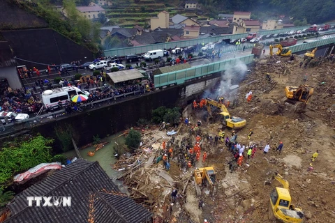 Lực lượng cứu hộ tìm kiếm nạn nhân tại hiện trường vụ lở đất ngày 14/11. (Nguồn: AFP/TTXVN)