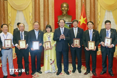 Chủ tịch nước Trần Đại Quang tặng chân dung Bác Hồ cho các doanh nhân tiêu biểu. (Ảnh: Nhan Sáng/TTXVN)