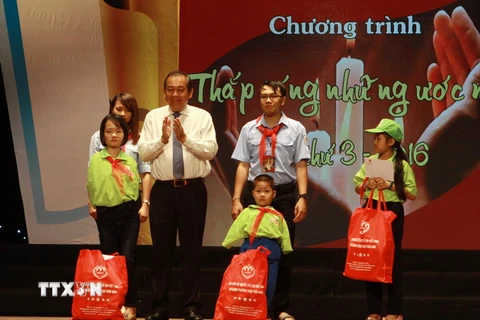 Phó Thủ tướng Trương Hòa Bình trao quà cho học sinh khó khăn. (Ảnh: Phương Vy/TTXVN)