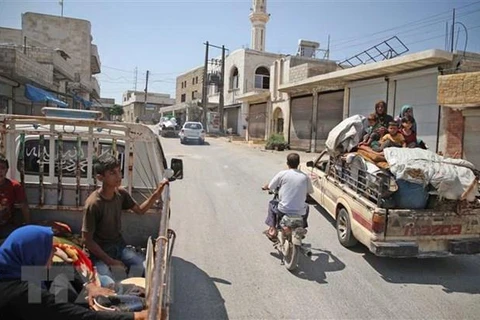 Người dân Syria trở về quê hương sau khi phải rời bỏ nhà cửa tránh chiến tranh. (Nguồn: AFP/TTXVN)