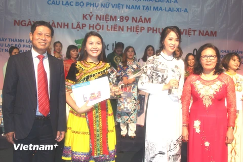 Hai thí sinh (đứng giữa) đoạt giải cao nhất cuộc thi. (Ảnh: Hoàng Nhương/Vietnam+)