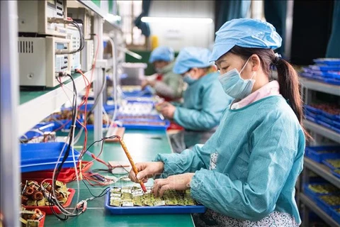 Công nhân kiểm tra linh kiện điện tử tại một nhà máy ở huyện Đào Viên, tỉnh Hồ Nam, Trung Quốc. (Ảnh: THX/TTXVN)