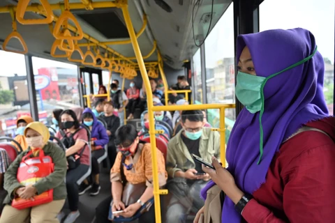 Hành khách đeo khẩu trang phòng lây nhiễm COVID-19 tại Jakarta, Indonesia. (Ảnh: AFP/TTXVN)