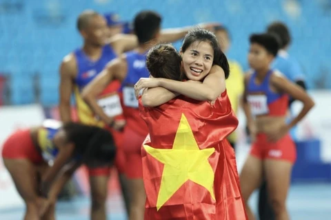 Niềm vui của Nguyễn Thị Huyền cùng đồng đội khi giành HCV nội dung 4x400m hỗn hợp. (Ảnh: Minh Quyết/TTXVN)