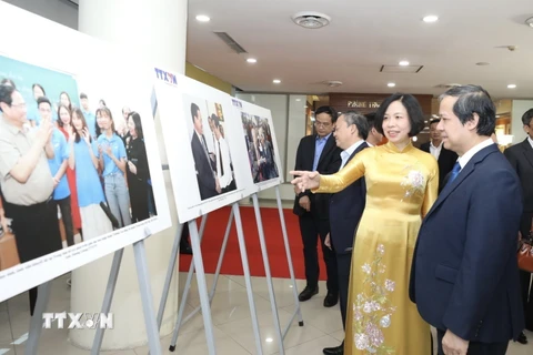 Tổng giám đốc TTXVN Vũ Việt Trang giới thiệu với Bộ trưởng Bộ Giáo dục và Đào tạo Nguyễn Kim Sơn về trưng bày những hình ảnh tiêu biểu của ngành giáo dục do TTXVN thực hiện. (Ảnh: Minh Quyết/TTXVN)