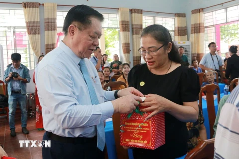 Trưởng Ban Tuyên giáo Trung ương Nguyễn Trọng Nghĩa tặng quà các gia đình có hoàn cảnh khó khăn tại ấp Tân Bắc, xã Bình Minh, huyện Trảng Bom, tỉnh Đồng Nai. (Ảnh: Lê Xuân/TTXVN)