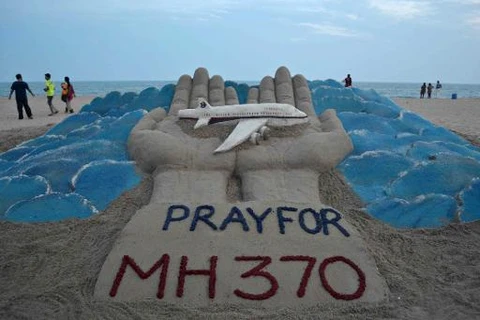 Cầu nguyện cho MH370 (Nguồn: AFP)