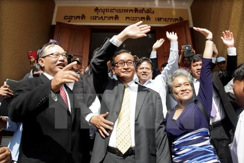 Thủ lĩnh Đảng Cứu nguy dân tộc Campuchia Sam Rainsy (giữa) tới tòa án ở Phnom Penh ngày 14/1. (Nguồn: THX/TTXVN)