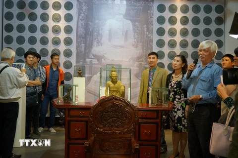 Các đại biểu tìm hiểu các hiện vật tại triển lãm 'Di sản Việt Nam - Góc nhìn mới.' (Ảnh: Đinh Thuận/TTXVN) 