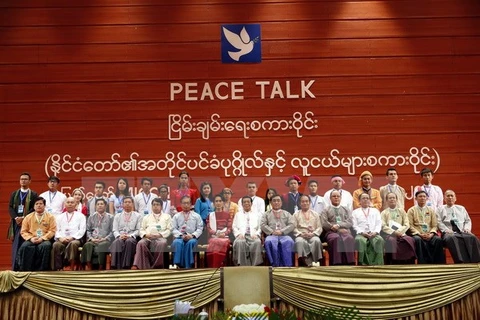 Cố vấn Nhà nước Aung San Suu Kyi (giữa) chụp ảnh với các đại biểu tại Hội nghị hòa bình ở Naypyitaw, Myanmar ngày 1/1. (Nguồn: EPA/TTXVN)