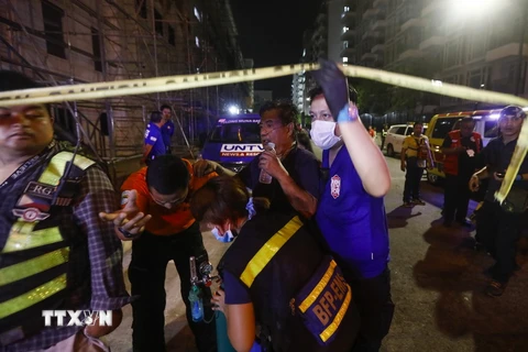 Sơ cứu người dân (thứ hai, phải) bị thương trong vụ khu nghỉ dưỡng Resort World Manila ở Manila bị tấn công ngày 2/6. (Nguồn: EPA/TTXVN)