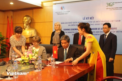 Bà Eva Kjer Hansen và Bộ trưởng Nguyễn Minh Quang ký kết Bản ghi nhớ giữa Bộ Tài nguyên-Môi trường trường Việt Nam và Diễn đàn tăng trưởng xanh toàn cầu. (Ảnh: Hùng Võ/Vietnam+)
