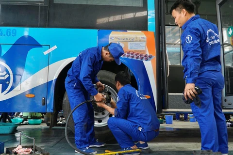 Những công nhân, thợ máy của các Xí nghiệp của Tổng công ty Vận tải Hà Nội tranh tài thi bảo dưỡng, sửa chữa xe buýt. (Ảnh: Minh Hiếu/Vietnam+)