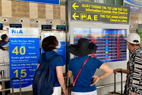 Hành khách theo dõi thông tin chuyến bay tại màn hình FIDS tại sân bay Nội Bài. (Ảnh: Văn phòng Cảng hàng không Nội Bài)