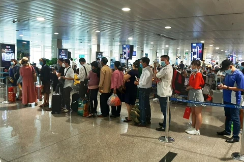 Hành khách làm thủ tục lên chuyến bay tại sân bay Tân Sơn Nhất. (Ảnh: Việt Hùng/Vietnam+)
