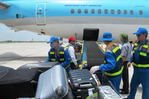 Nhân viên bốc xếp hành lý từ hầm hàng máy bay. (Ảnh minh hoạ. Nguồn: Việt Hùng/Vietnam+)