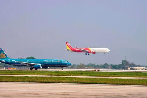 Máy bay của hai hãng hàng không Vietnam Airlines và Vietjet đang chuẩn bị cất, hạ cánh tại một sân bay. (Ảnh: PV/Vietnam+)