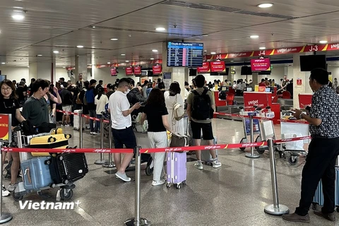 Hành khách làm thủ tục lên máy bay tại Cảng Hàng không Quốc tế Tân Sơn Nhất. (Ảnh: PV/Vietnam+)
