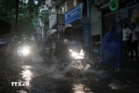 Hà Nội cố gắng hạn chế tình trạng ngập úng sau mưa tại các tuyến phố. (Ảnh: Tuấn Anh/TTXVN)