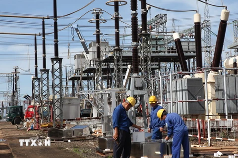 Công nhân Công ty Truyền tải điện 3 lắp đặt tụ bù dọc tại trạm biến áp 500kV Pleiku. (Ảnh: Ngọc Hà/TTXVN)