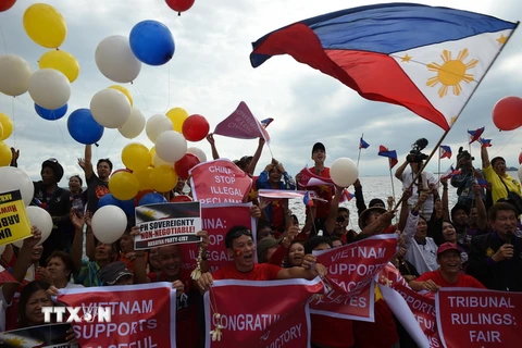 Các nhà hoạt động Philippines vui mừng sau phán quyết của Tòa Trọng tài ở Lahay trong cuộc tuần hành tại Manila ngày 12/7. (Nguồn: AFP/TTXVN)