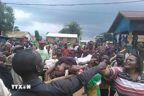 Người dân chờ bên ngoài một bệnh viện địa phương ở Beni để nhận diện thi thể người thân sau vụ thảm sát đêm 13/8. (Nguồn: AFP/TTXVN)
