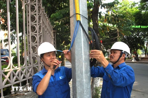 Công nhân VNPT Hà Giang lắp thiết bị phát wifi miễn phí. (Ảnh: Minh Tâm/TTXVN)