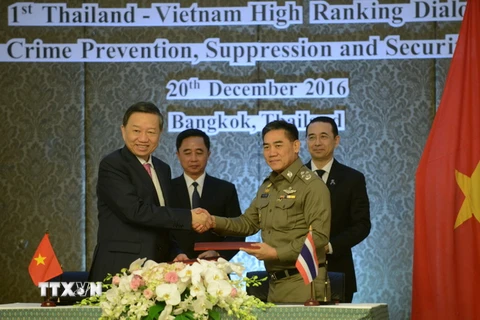 Bộ trưởng Công an Tô Lâm và Tư lệnh Cảnh sát Hoàng gia Thái Lan trao đổi văn kiện hợp tác. (Ảnh: Sơn Nam/TTXVN)