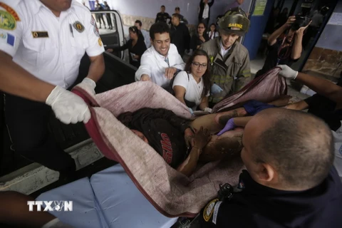 Chuyển em nhỏ bị thương trong vụ hỏa hoạn ở trung tâm tới bệnh viện San Juan de Dios ở Guatemala City, ngày 8/3. (Nguồn: AFP/TTXVN)