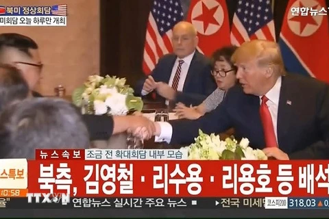 Tổng thống Mỹ Donald Trump (phải) và nhà lãnh đạo Triều Tiên Kim Jong-un (thứ 3, trái) tại cuộc hội đàm ở Sentosa, Singapore ngày 12/6. (Nguồn: YONHAP/TTXVN)