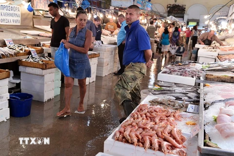 Người dân mua sắm tại một chợ hải sản ở Athens, Hy Lạp. (Nguồn: AFP/TTXVN)