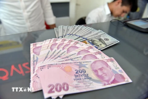 Đồng Lira của Thổ Nhĩ Kỳ (phía trước) và đồng USD tại quầy giao dịch tiền tệ ở Ankara, Thổ Nhĩ Kỳ ngày 10/8. (Ảnh: THX/TTXVN)