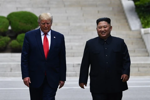 Tổng thống Mỹ Donald Trump (trái) và nhà lãnh đạo Triều Tiên Kim Jong-un trong cuộc gặp ở tại làng đình chiến Panmunjom ở biên giới liên Triều ngày 30/6/2019. (Ảnh: AFP/TTXVN)