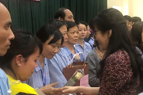 Cô giáo Nguyễn Thị Thu Anh, hiệu trưởng Trường THCS và THPT Nguyễn Tất Thành trao quà cho các đồng nghiệp đang điều trị tại Bệnh viện K Trung ương, cơ sở Tân Triều. (Ảnh: PV/Vietnam+)